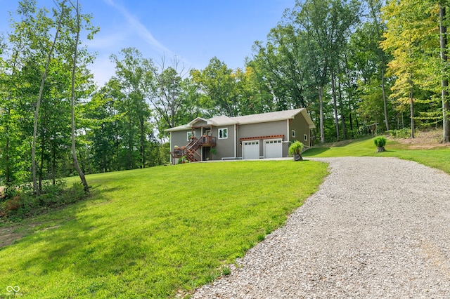 view of front of property featuring a garage and a front lawn