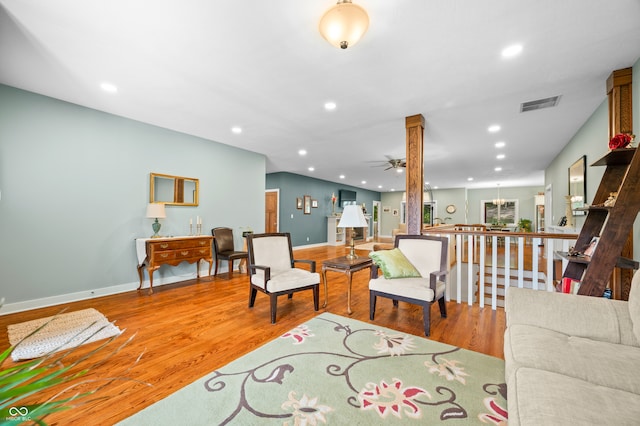 living room with ceiling fan and hardwood / wood-style flooring