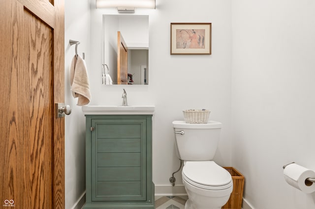 bathroom featuring toilet and vanity