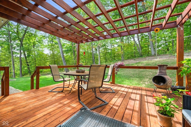 wooden deck with a lawn and a pergola