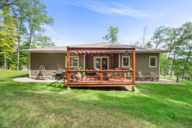 back of property featuring a patio area, a lawn, and a wooden deck