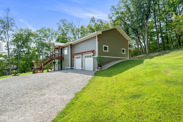 view of side of property featuring a garage and a yard