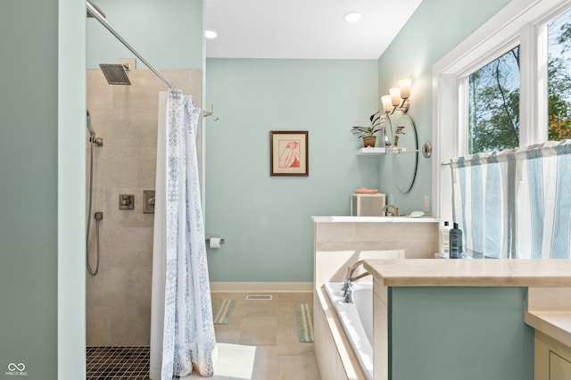 bathroom with vanity, plus walk in shower, and tile patterned flooring