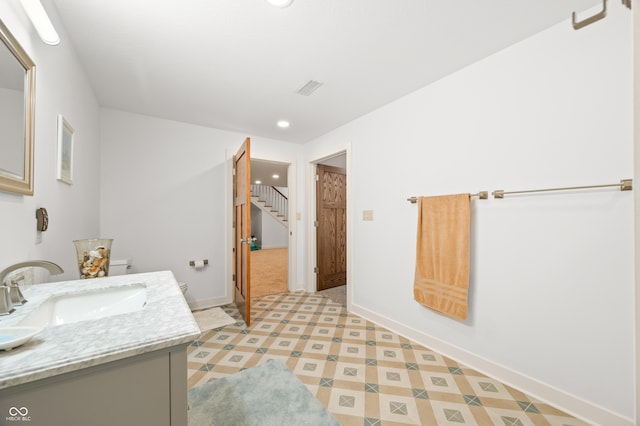 bathroom featuring toilet and vanity