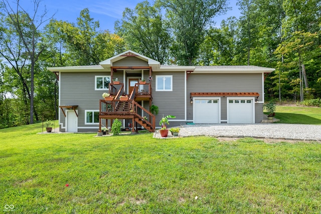 view of front of house featuring a garage, a deck, and a front lawn