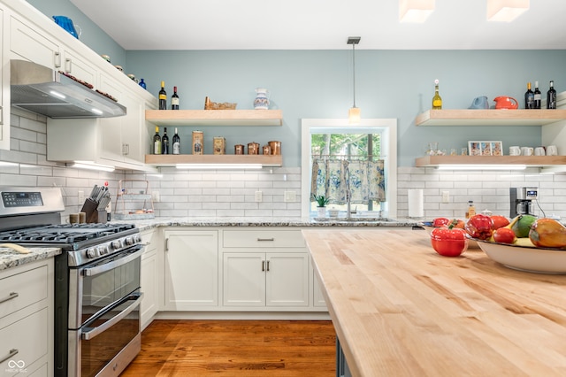 kitchen featuring white cabinets, hardwood / wood-style flooring, wood counters, decorative light fixtures, and stainless steel gas stove