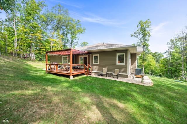 back of property with central AC, a lawn, and a wooden deck