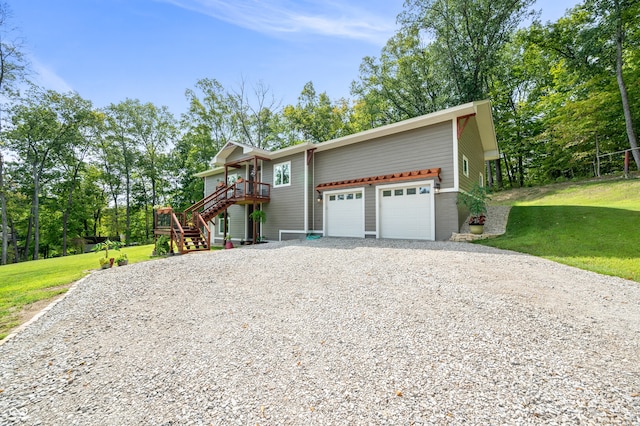 exterior space featuring a front yard and a wooden deck