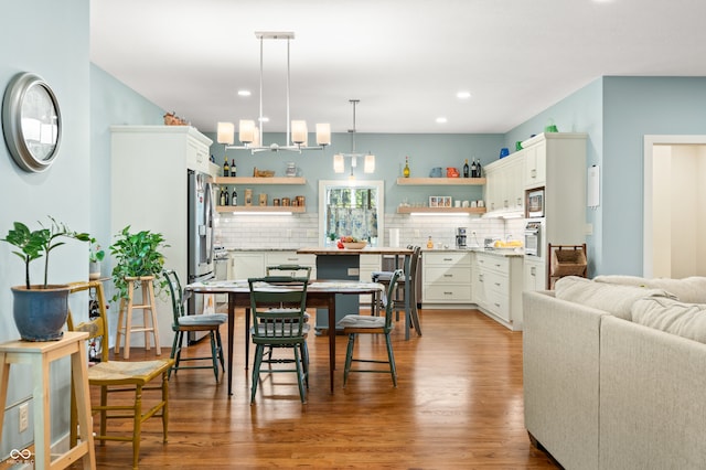 dining area with hardwood / wood-style flooring and a chandelier