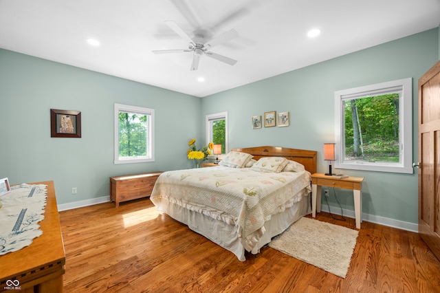 bedroom with hardwood / wood-style floors and ceiling fan