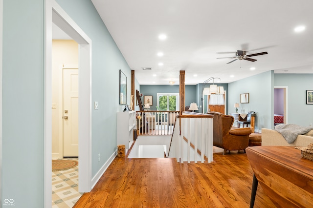 corridor with light hardwood / wood-style floors