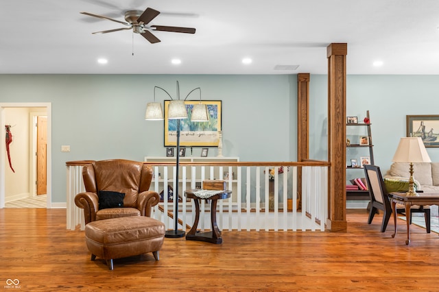 living area featuring ceiling fan and hardwood / wood-style floors