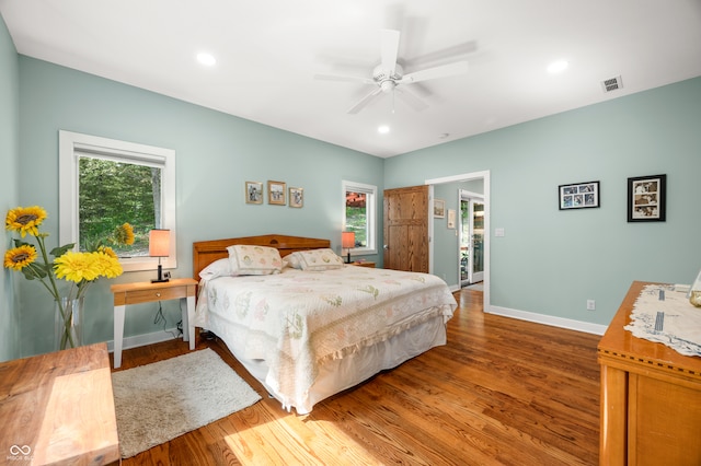 bedroom with ceiling fan and dark hardwood / wood-style flooring