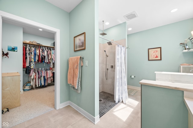 bathroom featuring curtained shower and tile patterned floors