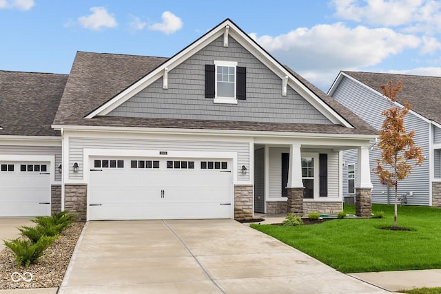 craftsman-style house featuring a garage and a front lawn