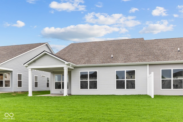 rear view of property with a lawn