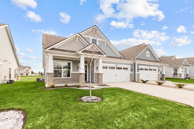 craftsman inspired home featuring central air condition unit, a front yard, and a garage