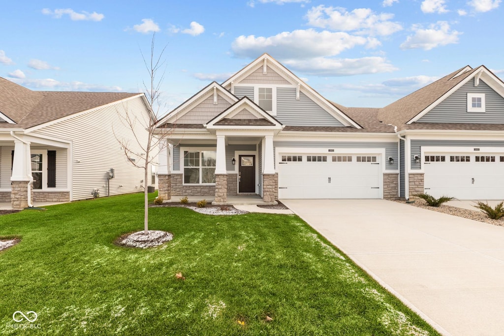 craftsman-style home with a garage and a front lawn