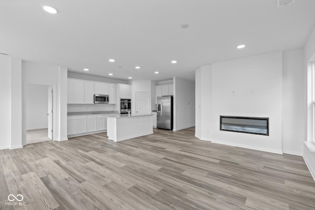 unfurnished living room with light hardwood / wood-style flooring