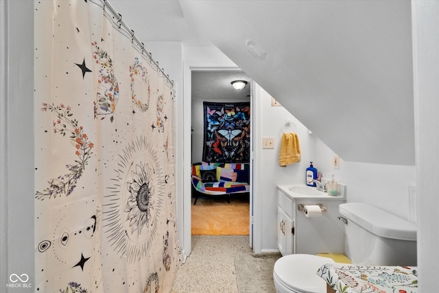 bathroom with curtained shower, vaulted ceiling, toilet, and vanity