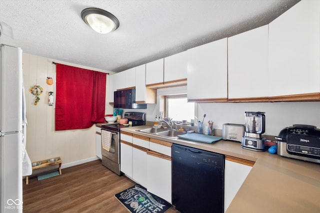 kitchen featuring black appliances, white cabinetry, and sink