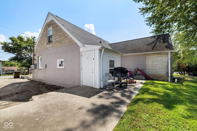 view of side of home featuring a lawn