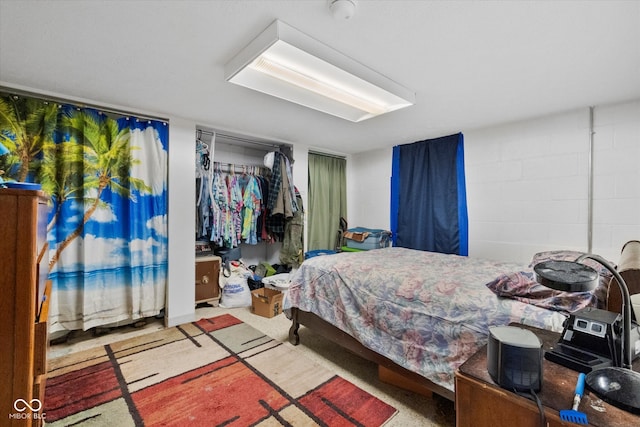 bedroom featuring a closet and light carpet