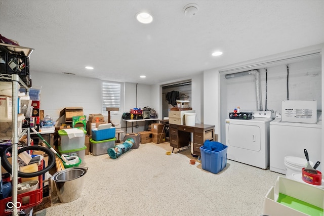 basement with a textured ceiling and washer and clothes dryer