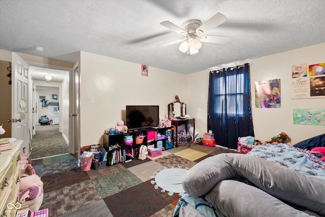 bedroom with a textured ceiling, ceiling fan, and carpet floors