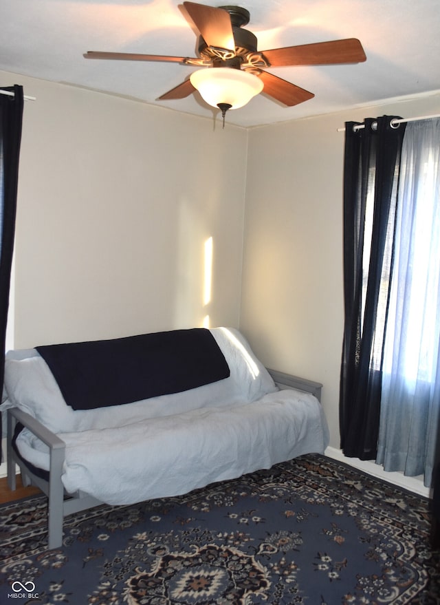 bedroom featuring multiple windows and ceiling fan