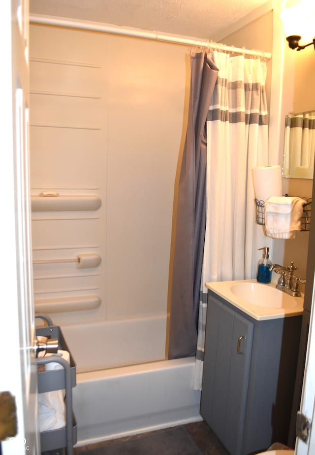 bathroom with shower / tub combo, a textured ceiling, and vanity