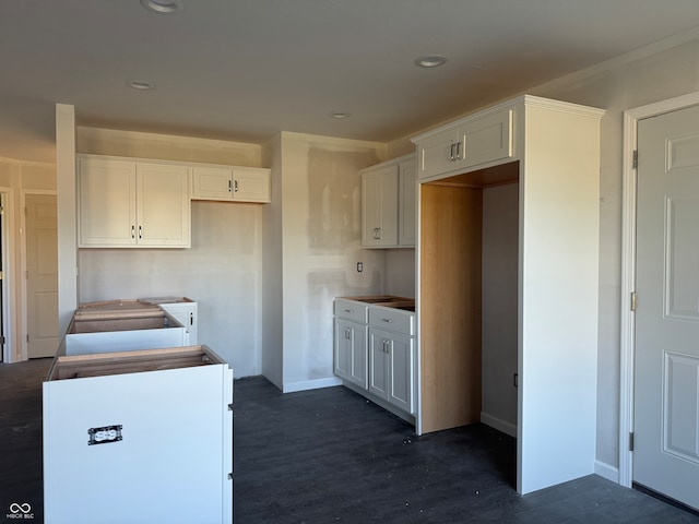 kitchen featuring white cabinetry and dark hardwood / wood-style floors