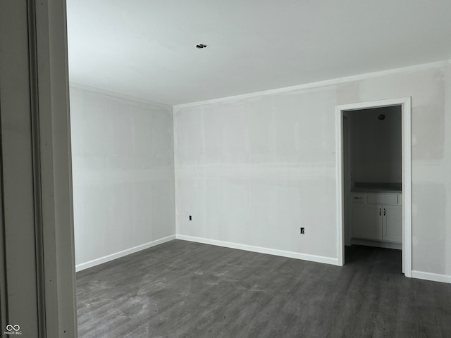 spare room with dark wood-type flooring