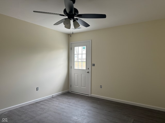 spare room featuring ceiling fan and dark hardwood / wood-style flooring