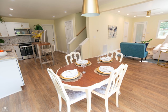 dining space featuring light hardwood / wood-style flooring and ceiling fan