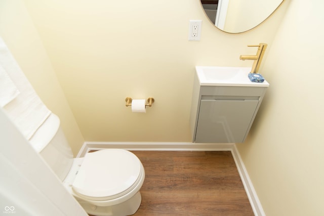 bathroom featuring hardwood / wood-style floors, vanity, and toilet