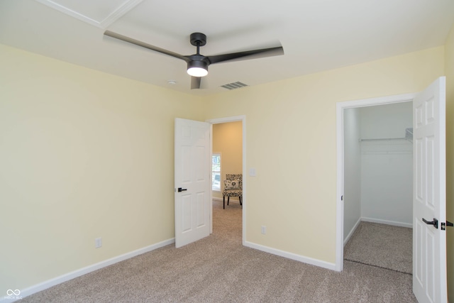 unfurnished bedroom with ceiling fan, light colored carpet, and a closet