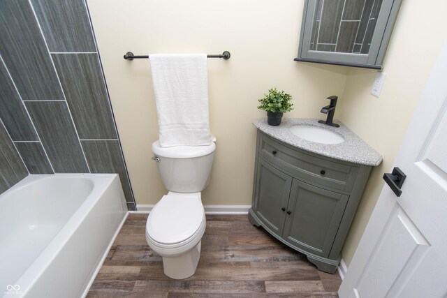 full bathroom featuring toilet, vanity, shower / bath combination, and hardwood / wood-style flooring