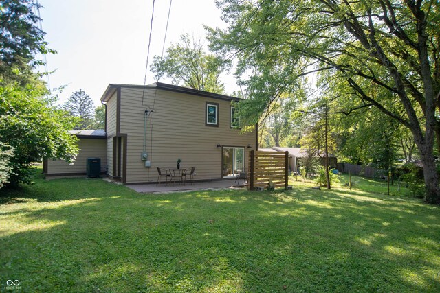 back of house with a patio, cooling unit, and a lawn