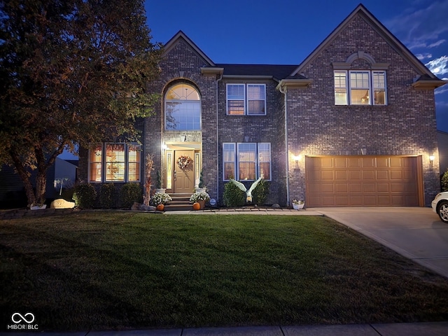 view of front facade with a yard and a garage