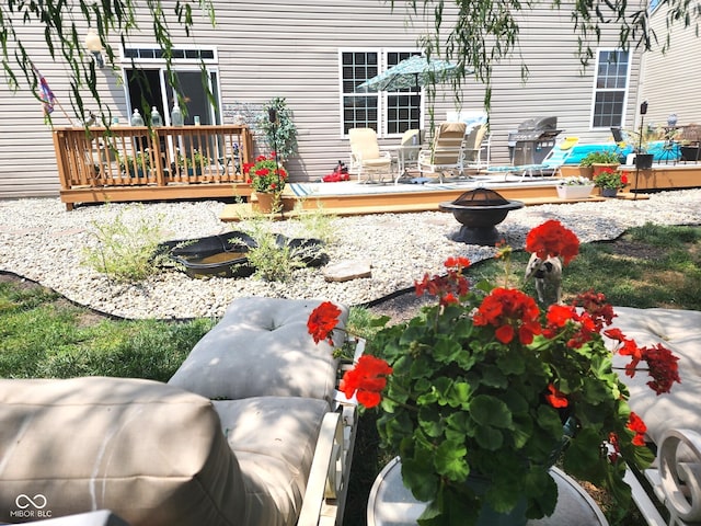 view of yard featuring a wooden deck and an outdoor fire pit