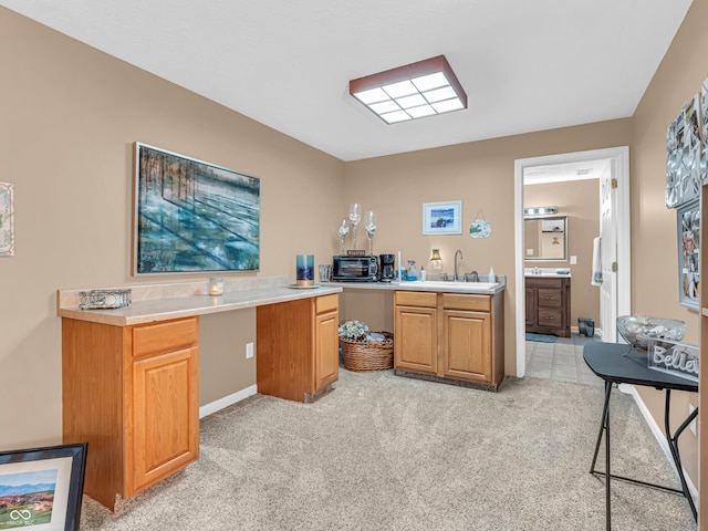 kitchen featuring light colored carpet and sink