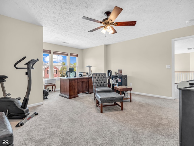 interior space featuring light carpet, a textured ceiling, and ceiling fan