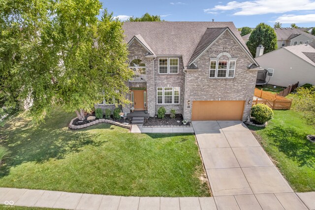 view of front of home featuring a garage and a front yard