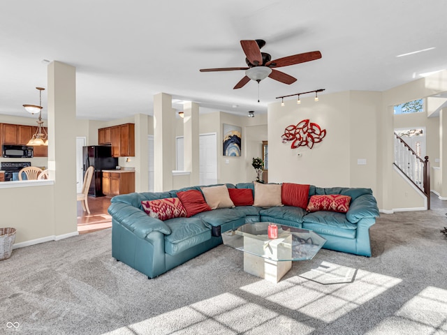 carpeted living room with ceiling fan and track lighting