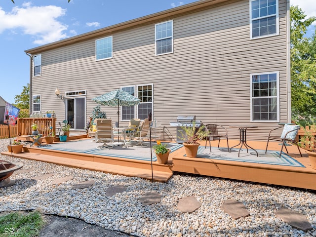 rear view of property featuring a deck