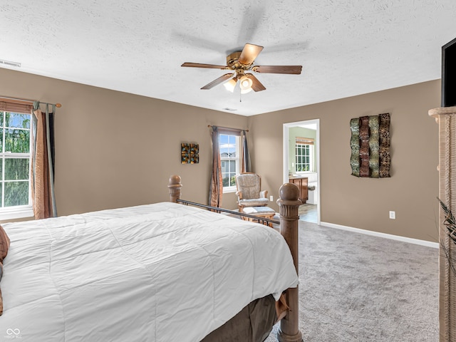 carpeted bedroom featuring a textured ceiling and ceiling fan