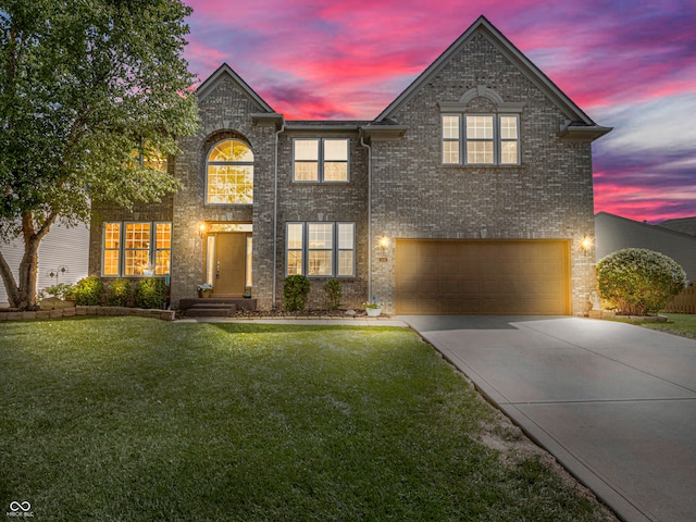 view of front of house with a garage and a lawn