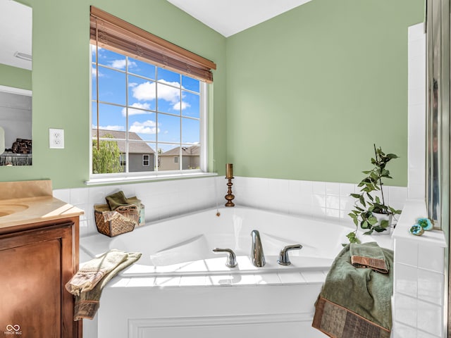 bathroom featuring vanity and a bath