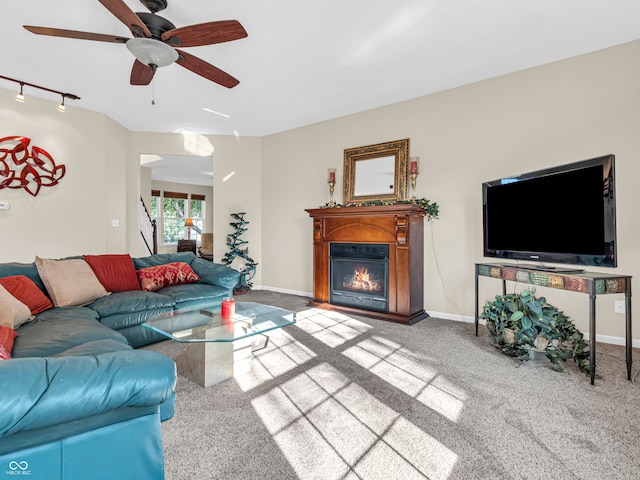 carpeted living room featuring ceiling fan and track lighting